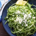 spiralized cucumber feta and mint salad on blue plate