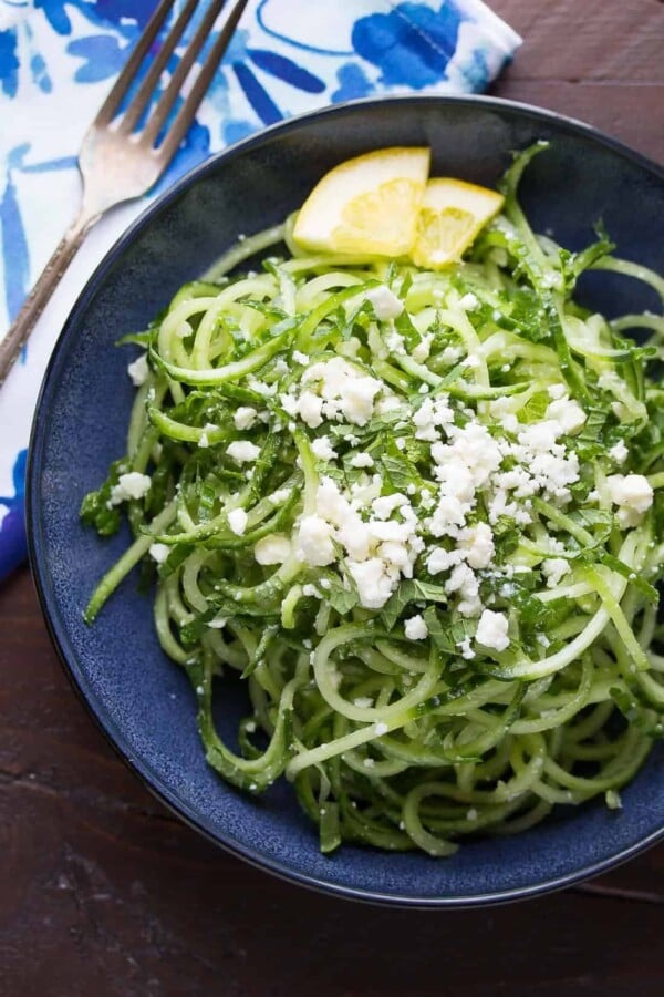 spiralized cucumber feta and mint salad on blue plate
