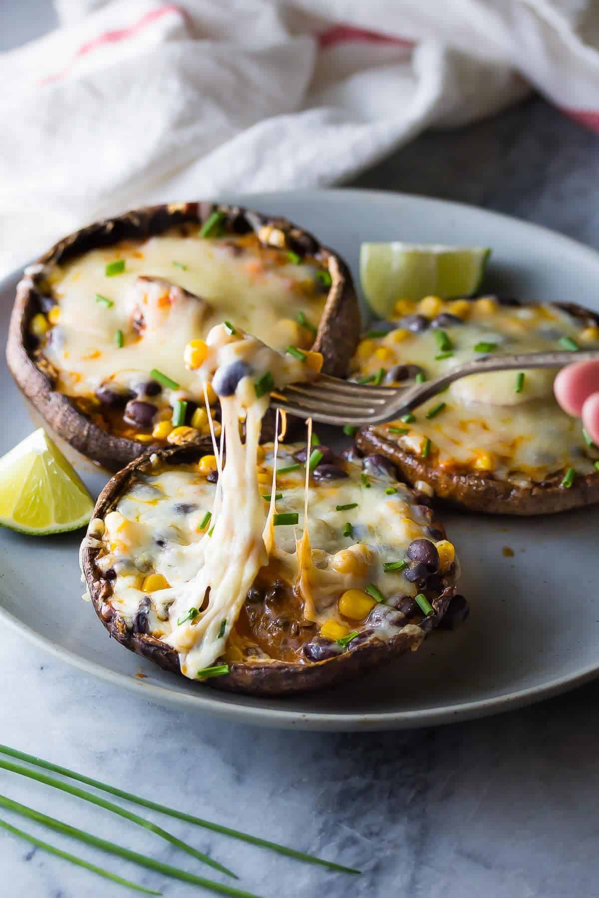 Fork digging into Enchilada Stuffed Grilled Portobello Mushrooms