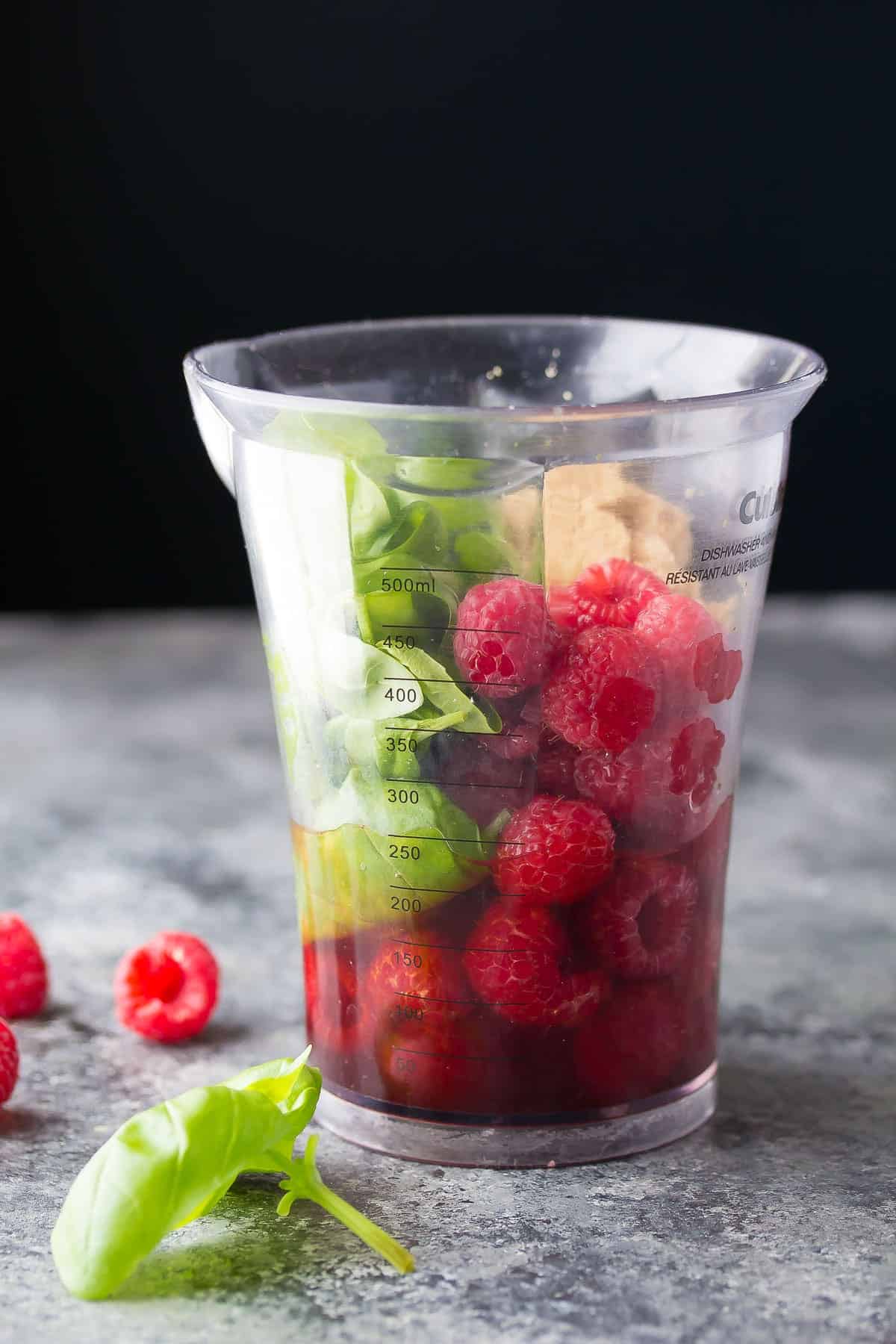 side view of ingredients required to make raspberry vinaigrette in immersion blender jar
