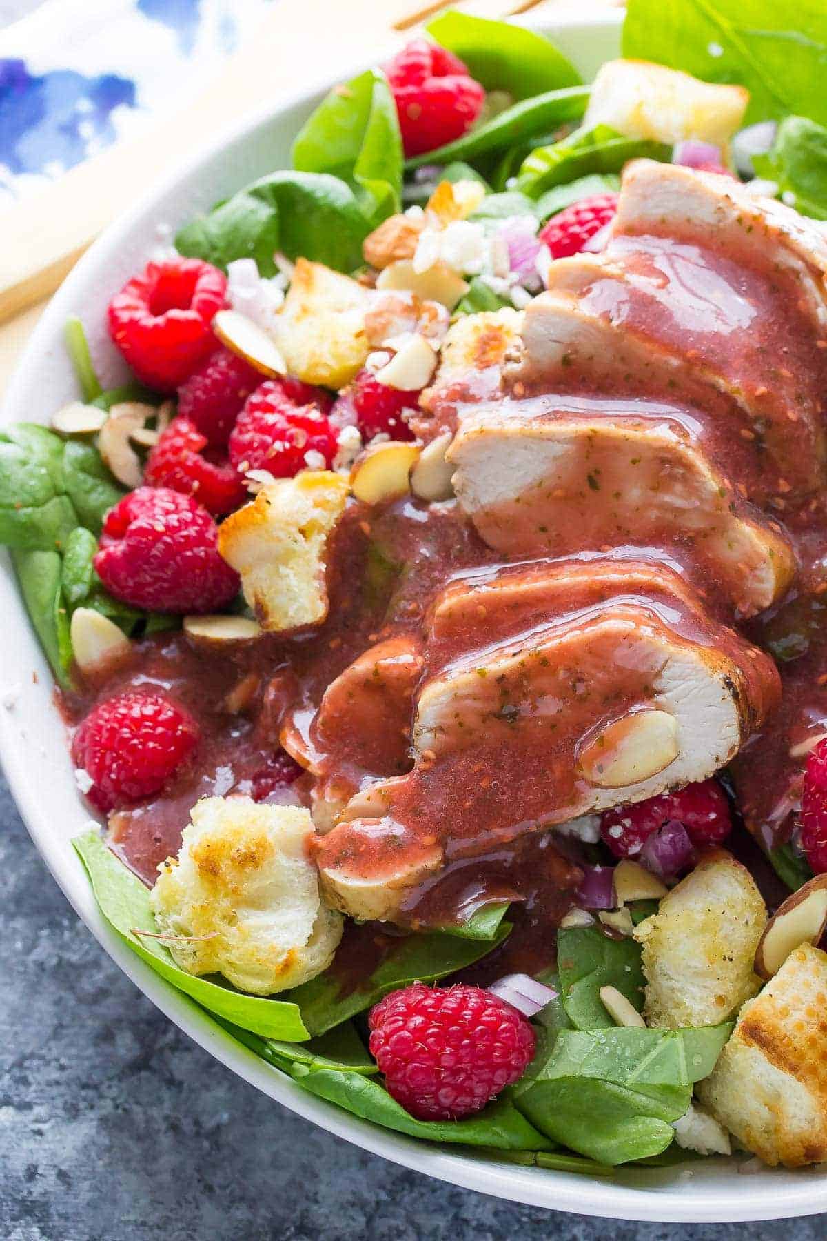 Close up of Raspberry Spinach Panzanella Salad with Chicken - covered in Raspberry Basil Vinaigrette