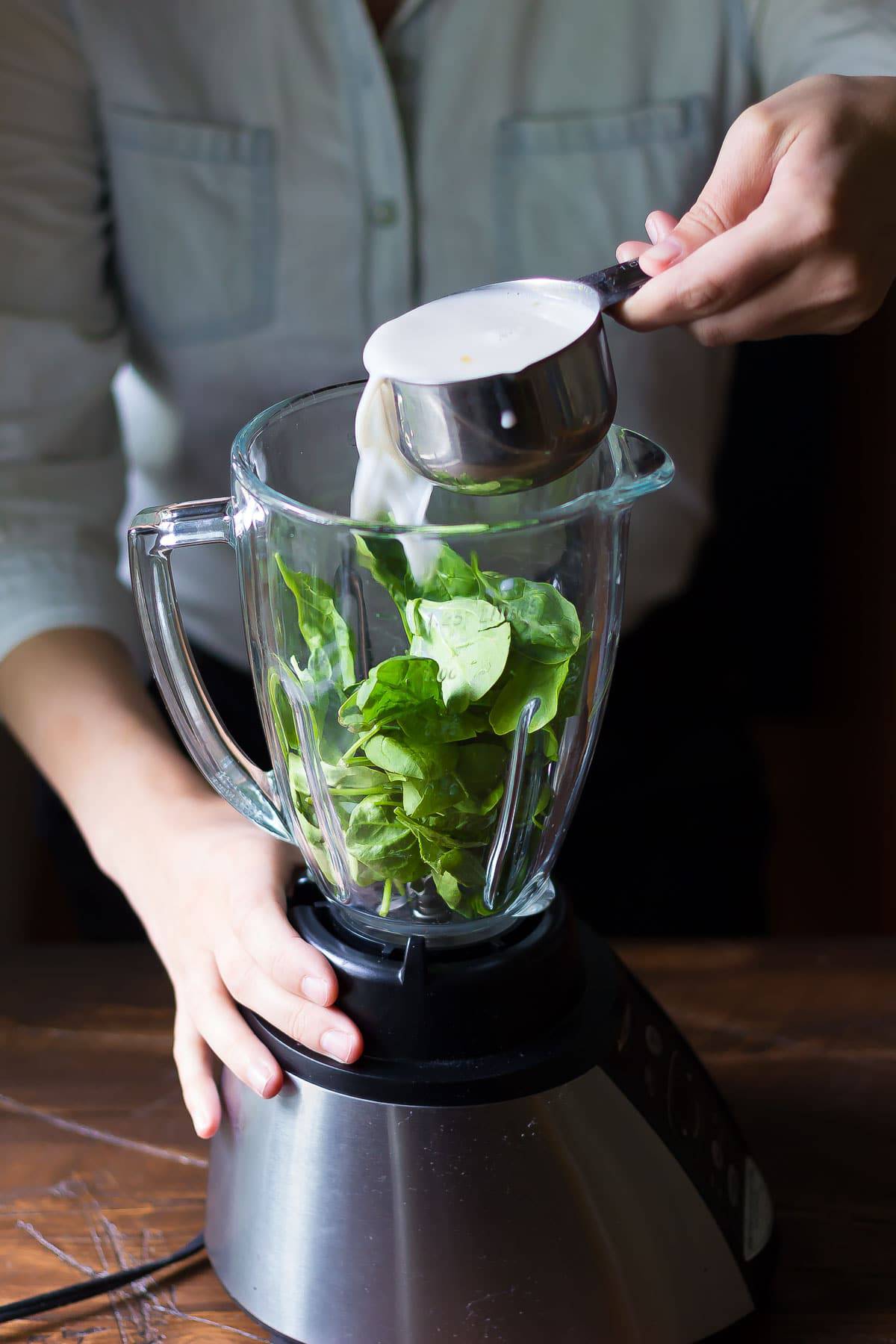 pouring almond milk into the blender