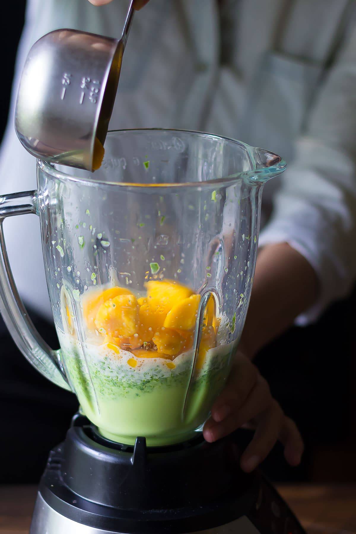 Adding mango into the blender