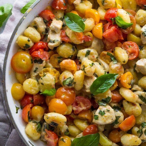 overhead shot of caprese gnocchi skillet with basil