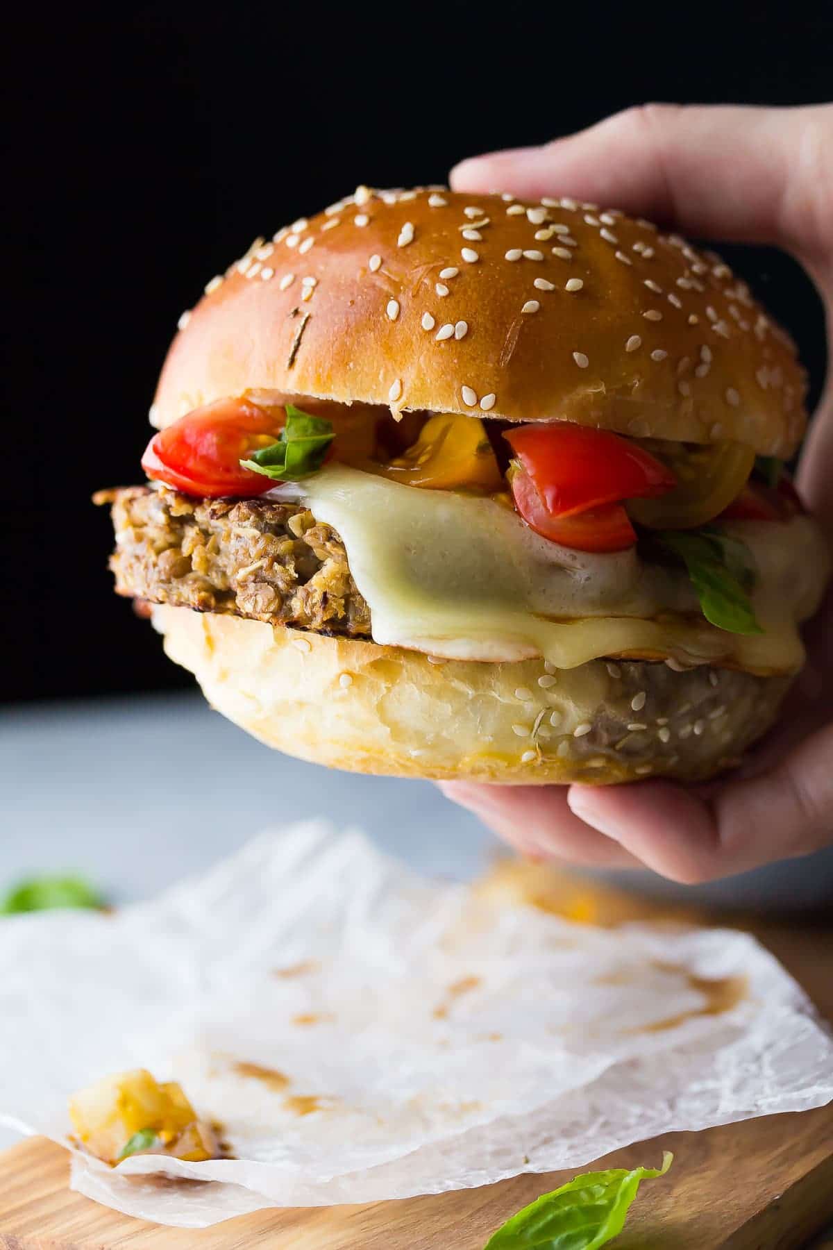 Hand Holding Mushroom and Lentil Bruschetta Burger