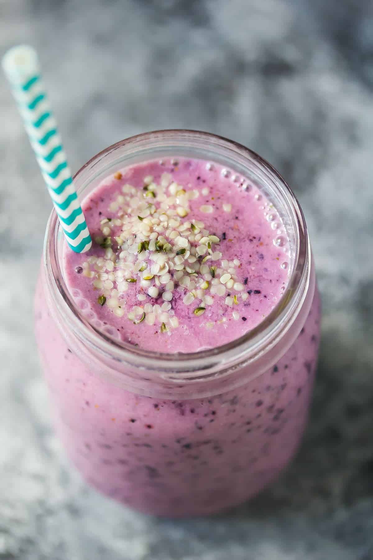 Blueberry Coconut Water Smoothie in a mason jar with Hemp Hearts on top
