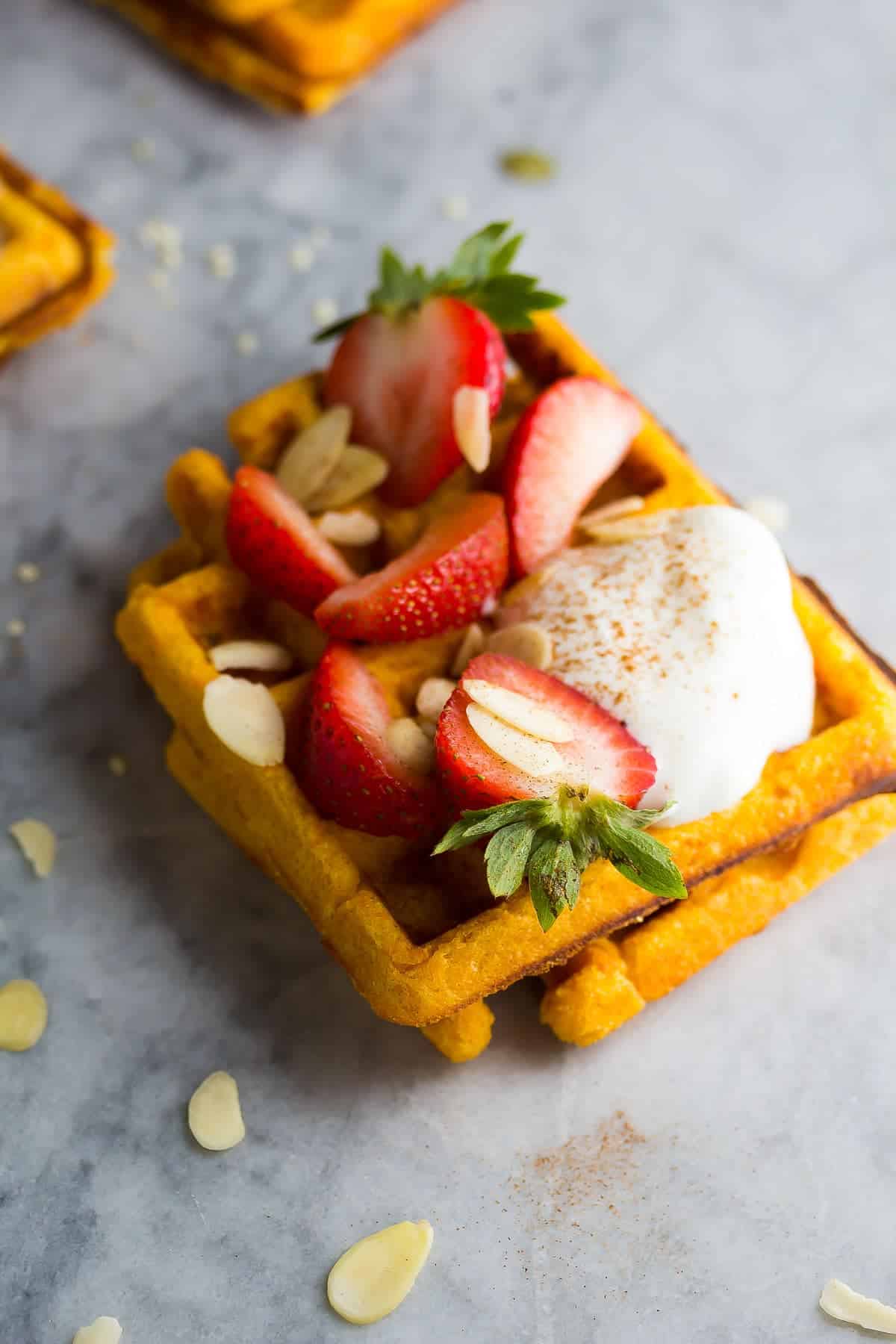 Sweet Potato Waffle with yogurt, strawberries and almonds on top