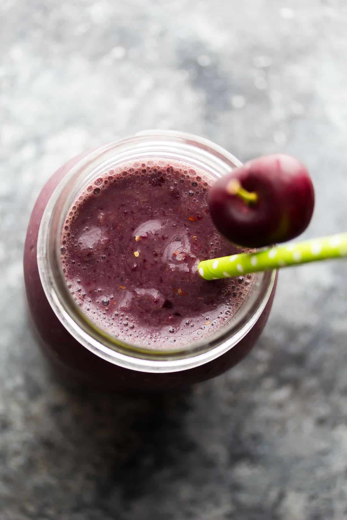 overhead view of goji peach cherry peach smoothie in cup