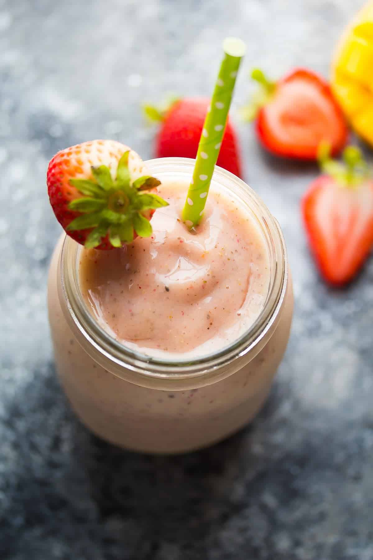 chai spiced Strawberry Mango Smoothie in mason jar with a straw