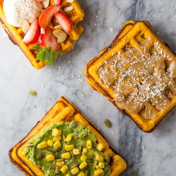 three sweet potato waffles with a variety of toppings