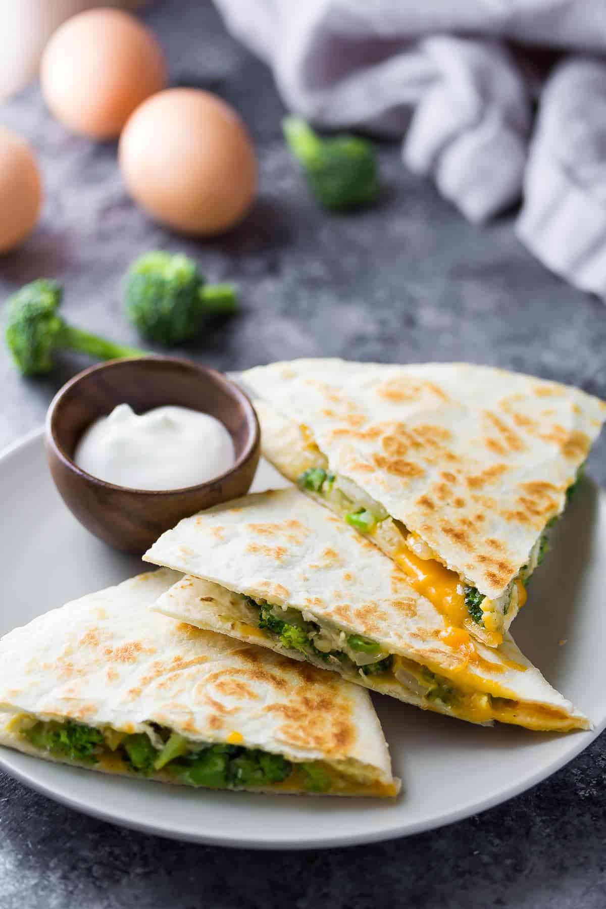 Broccoli Cheddar Breakfast Quesadillas plated with dipping sauce