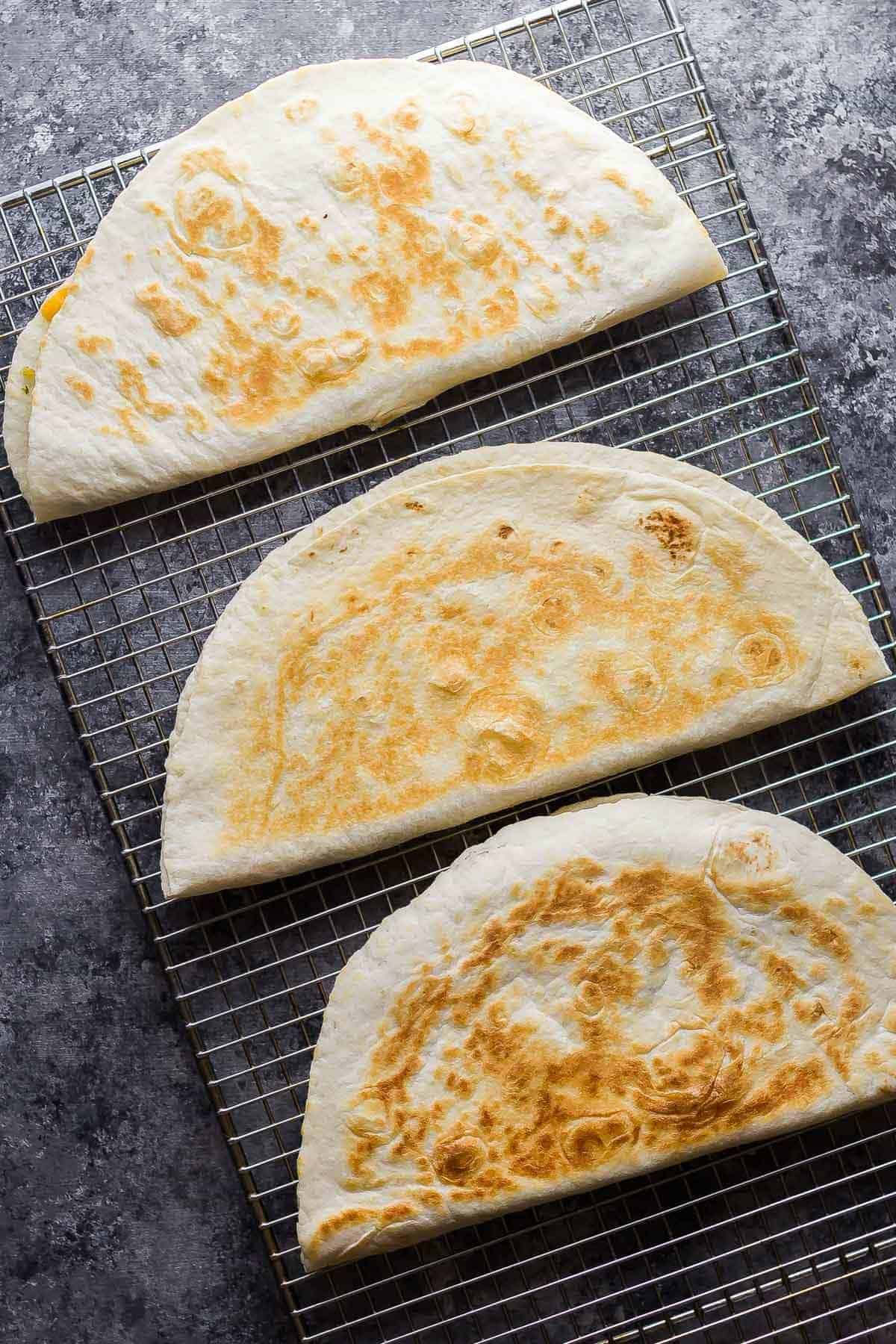 breakfast quesadillas cooling on wire rack