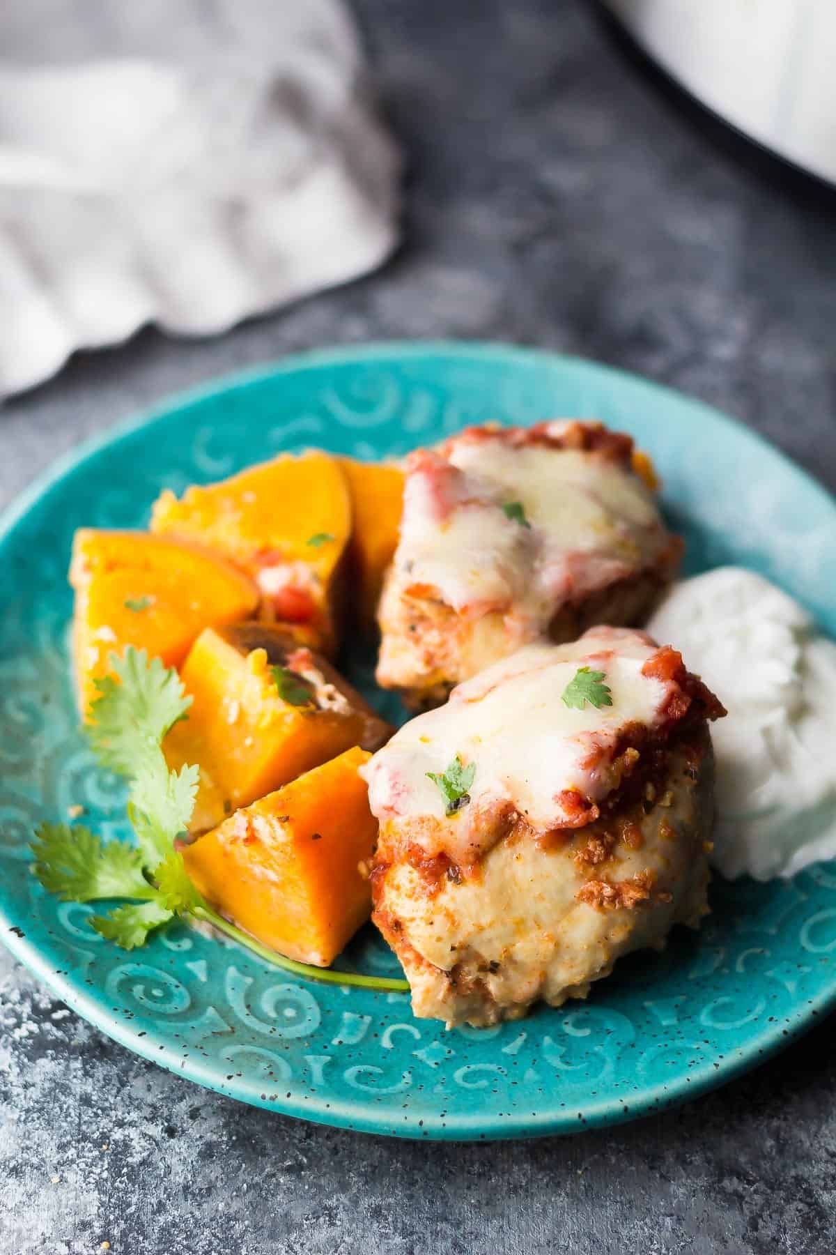 Southwestern crockpot Chicken Thighs and Sweet Potatoes on blue plate