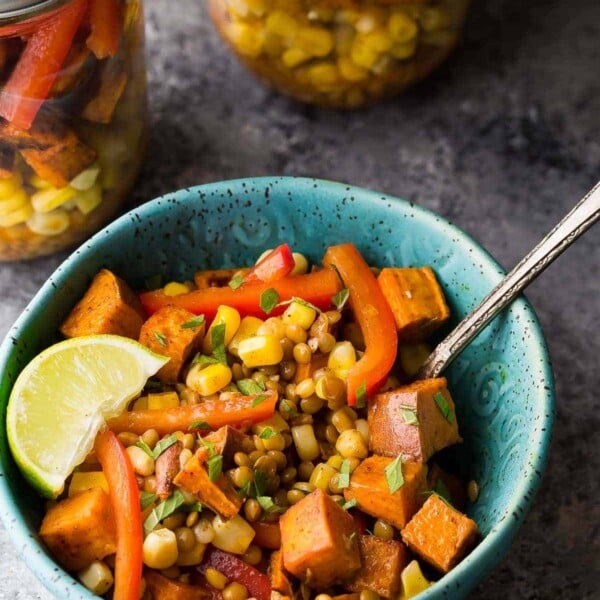 southwestern lentil sweet potato lunch bowl in blue bowl with lime