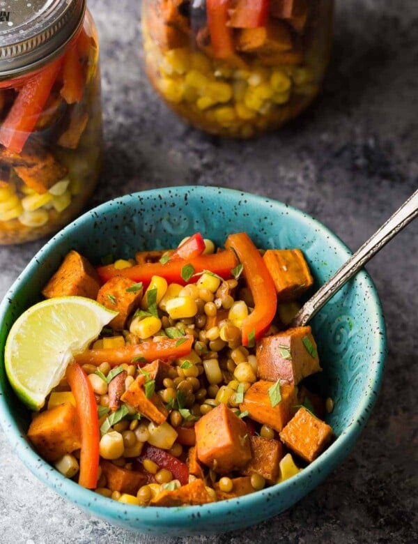southwestern lentil sweet potato lunch bowl in blue bowl with lime