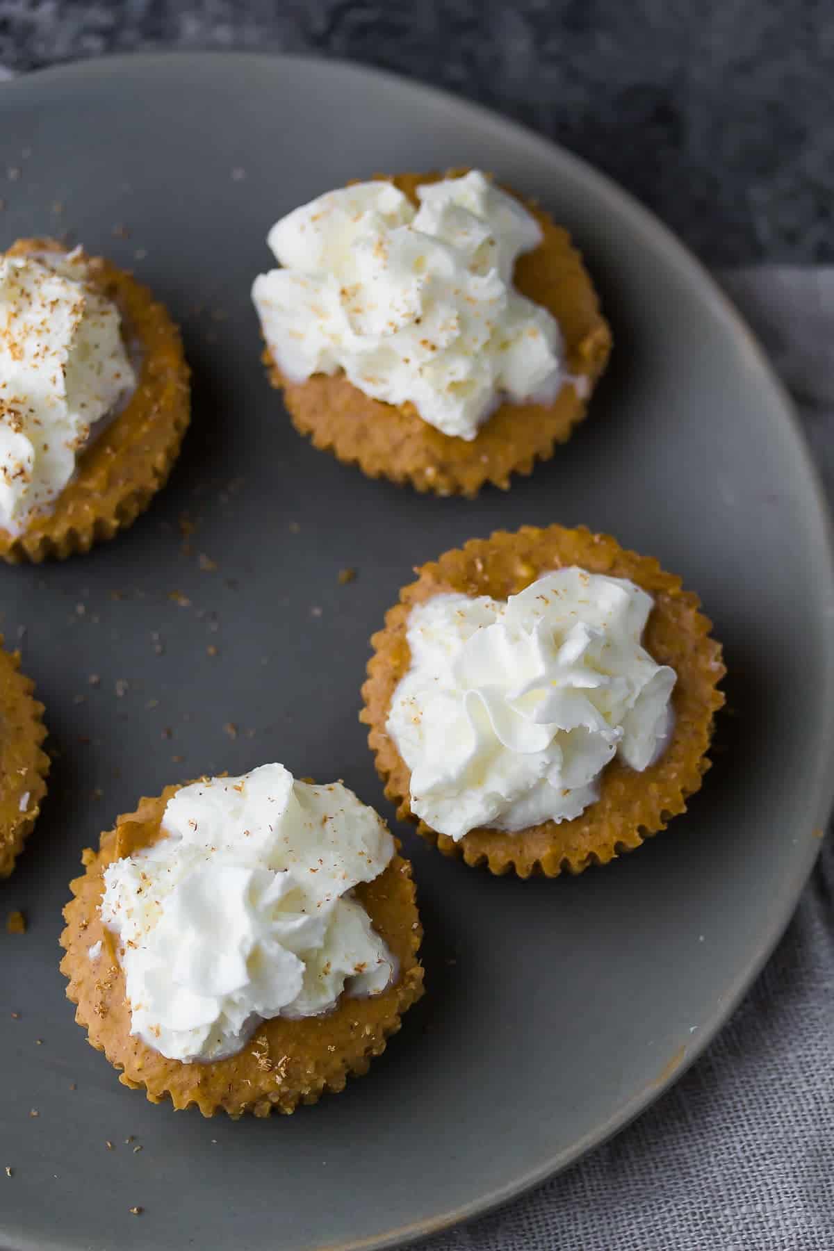 overhead view of mini pumpkin cheesecakes on plate