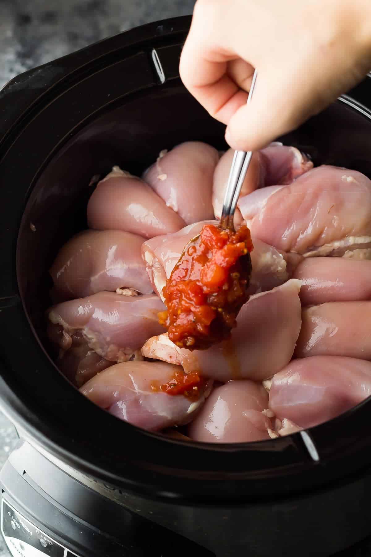 Putting Southwestern crockpot Chicken ingredients in crockpot