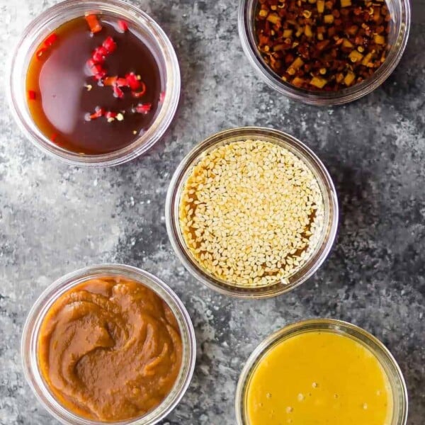 overhead shot of 7 easy stir fry sauces on gray background