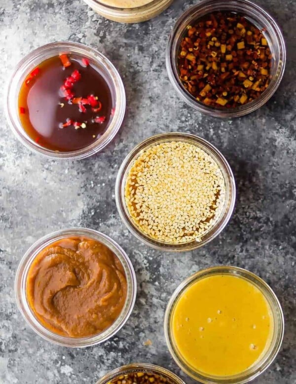overhead shot of 7 easy stir fry sauces on gray background