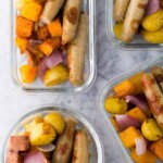 overhead shot of four glass meal prep containers with sausage breakfast bowls