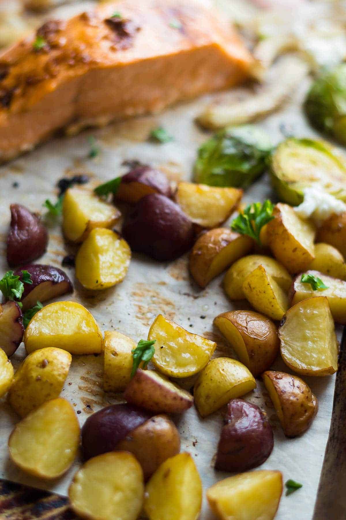 Roasted Mediterranean salmon and potatoes on a baking sheet