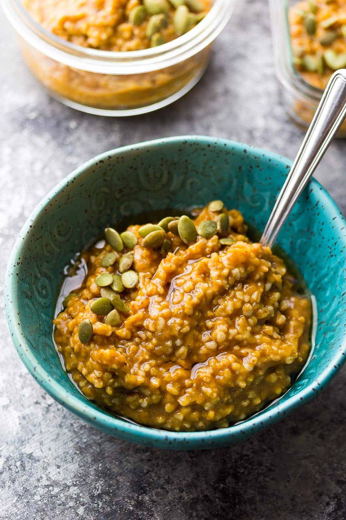 a bowl of pumpkin steel cut oats topped with pumpkin seeds