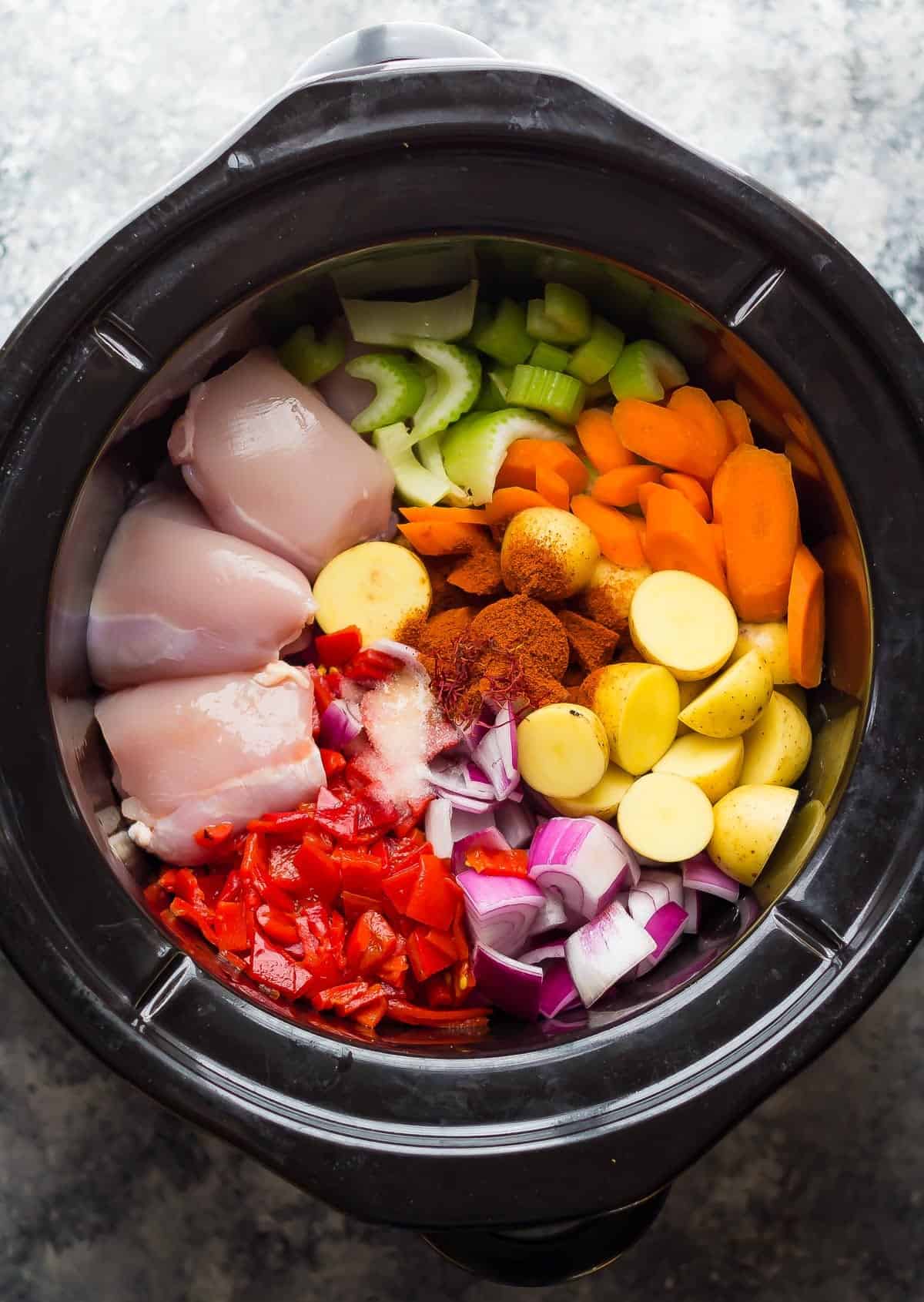 ingredients for spanish chicken stew in the slow cooker before cooking