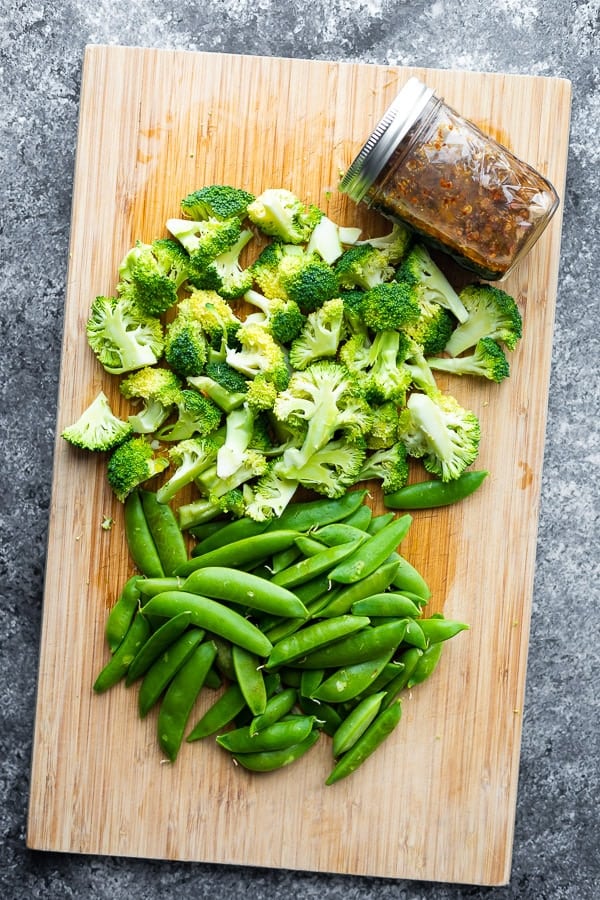 vegetables and stir fry sauce on cutting board for honey sesame chicken
