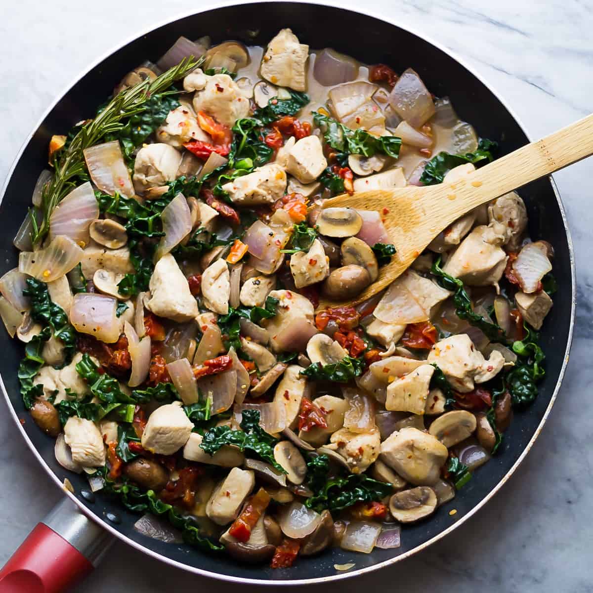 overhead view of side angle view of tuscan chicken skillet