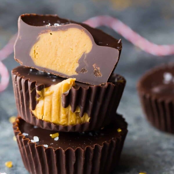 stack of three salted dark chocolate cookie butter cups on gray counter