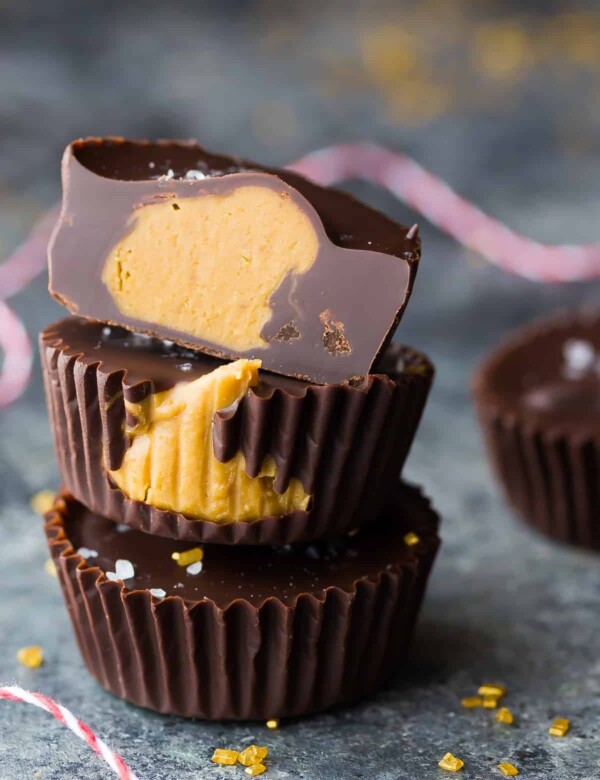 stack of three salted dark chocolate cookie butter cups on gray counter