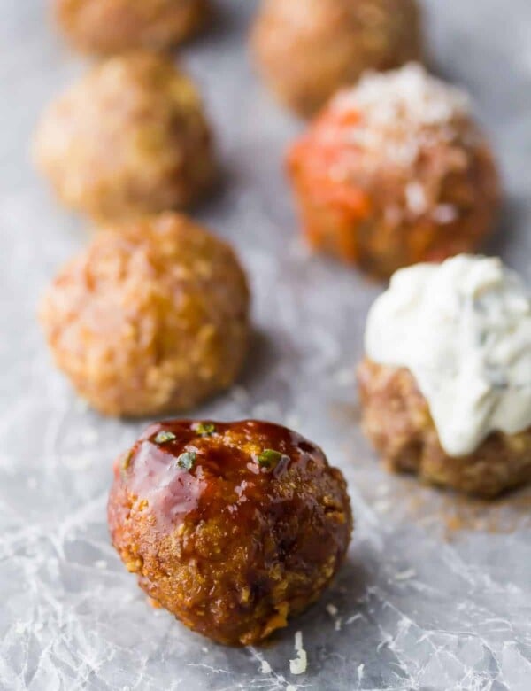 five baked turkey meatballs lined up on parchment paper