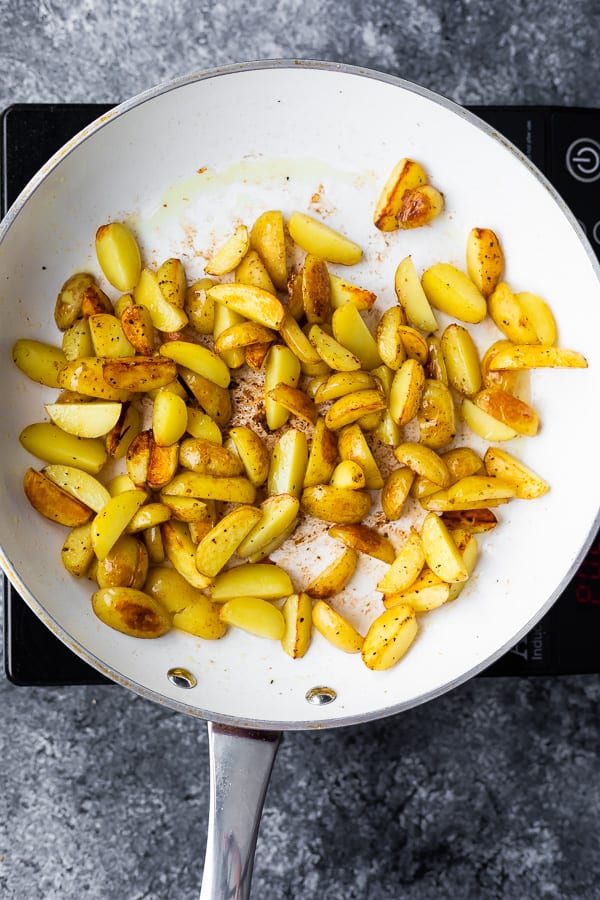 cooking the potatoes for the one pan chicken and potatoes in a frying pan