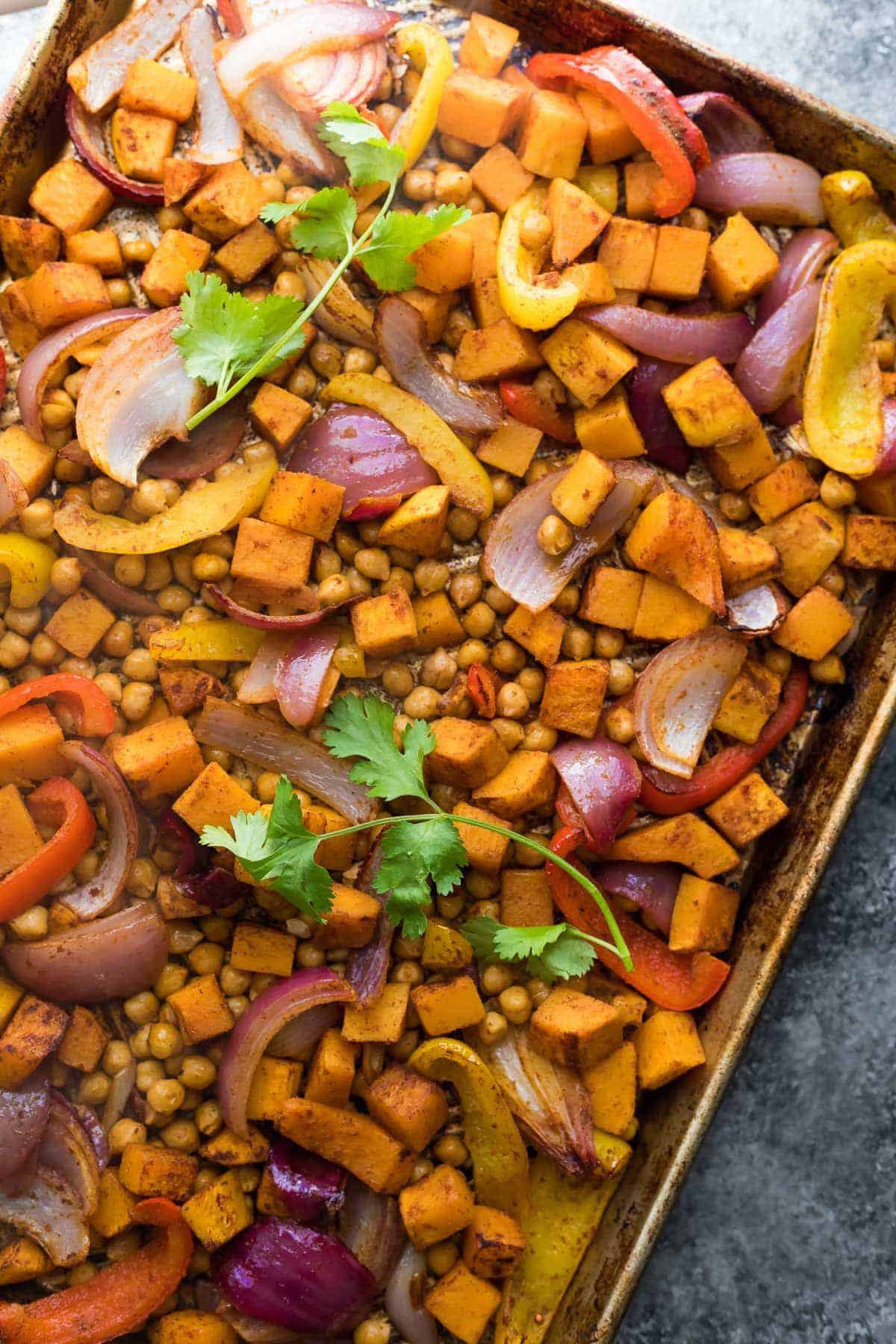 Ingredients for Chickpea Butternut Squash Fajitas spread evenly on baking sheet