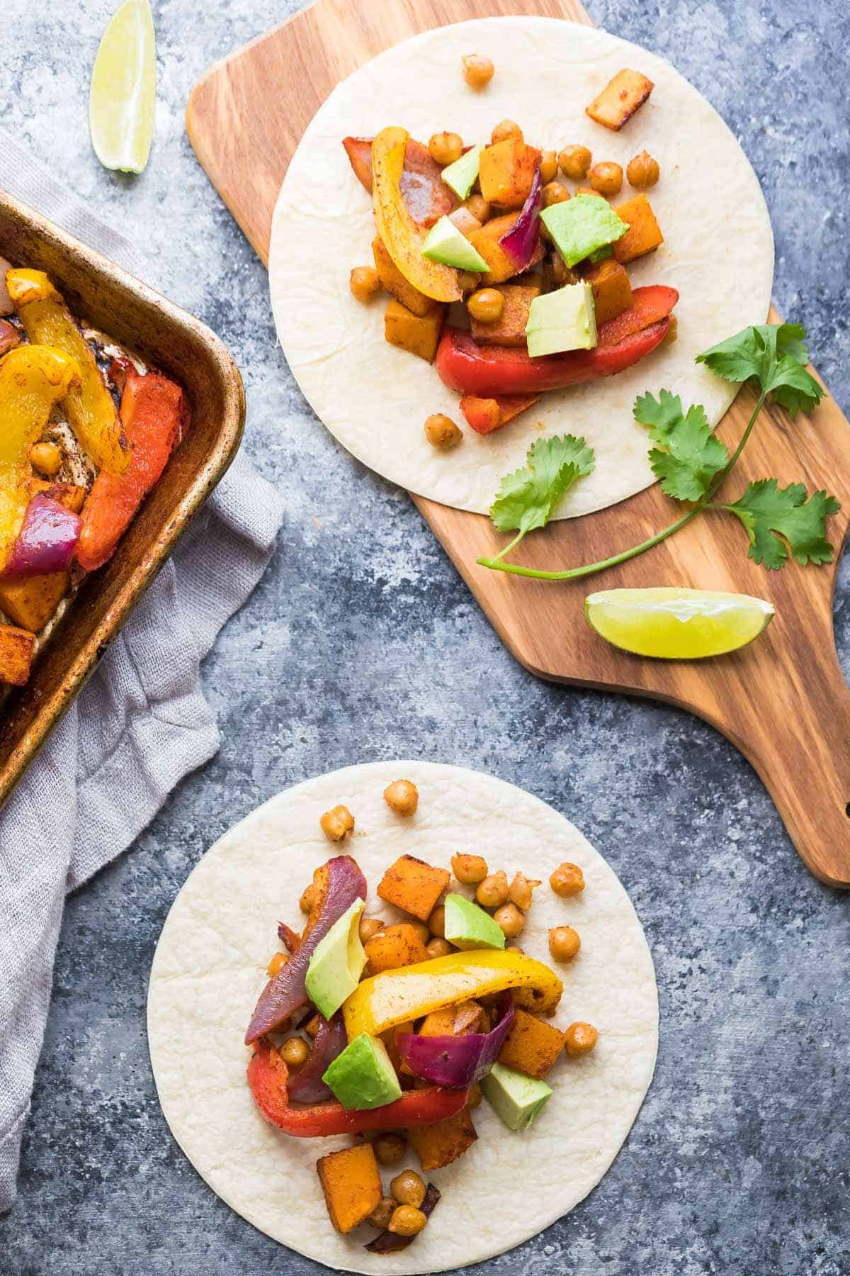 Overhead view of Chickpea Butternut Squash Fajitas in flour tortilla on wood cutting board