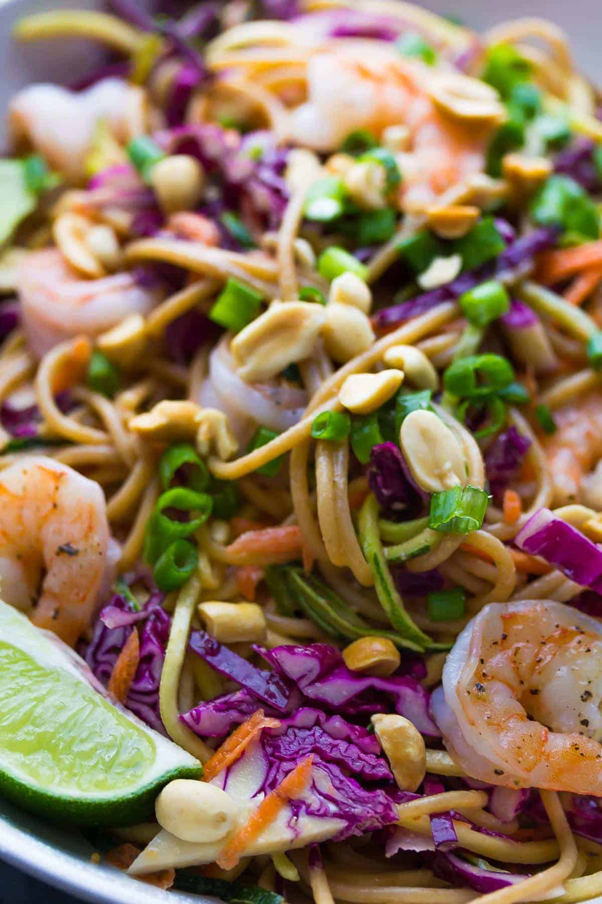 Close up shot of Spiralized Veggie Thai Noodle Bowls with lime wedge