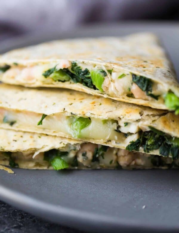 stack of three white bean kale quesadillas on gray plate