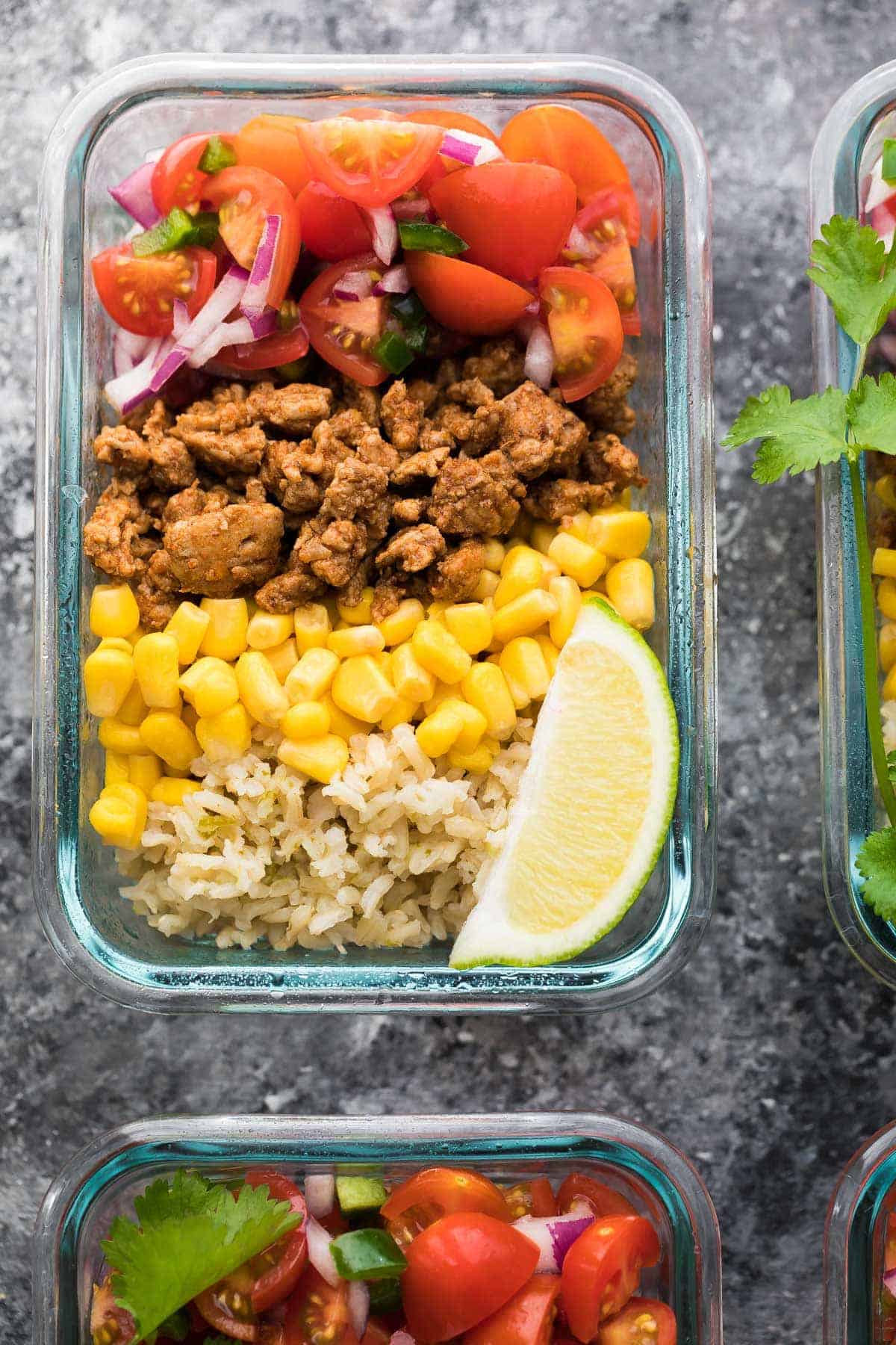 close up shot of turkey taco lunch bowls with lime wedge