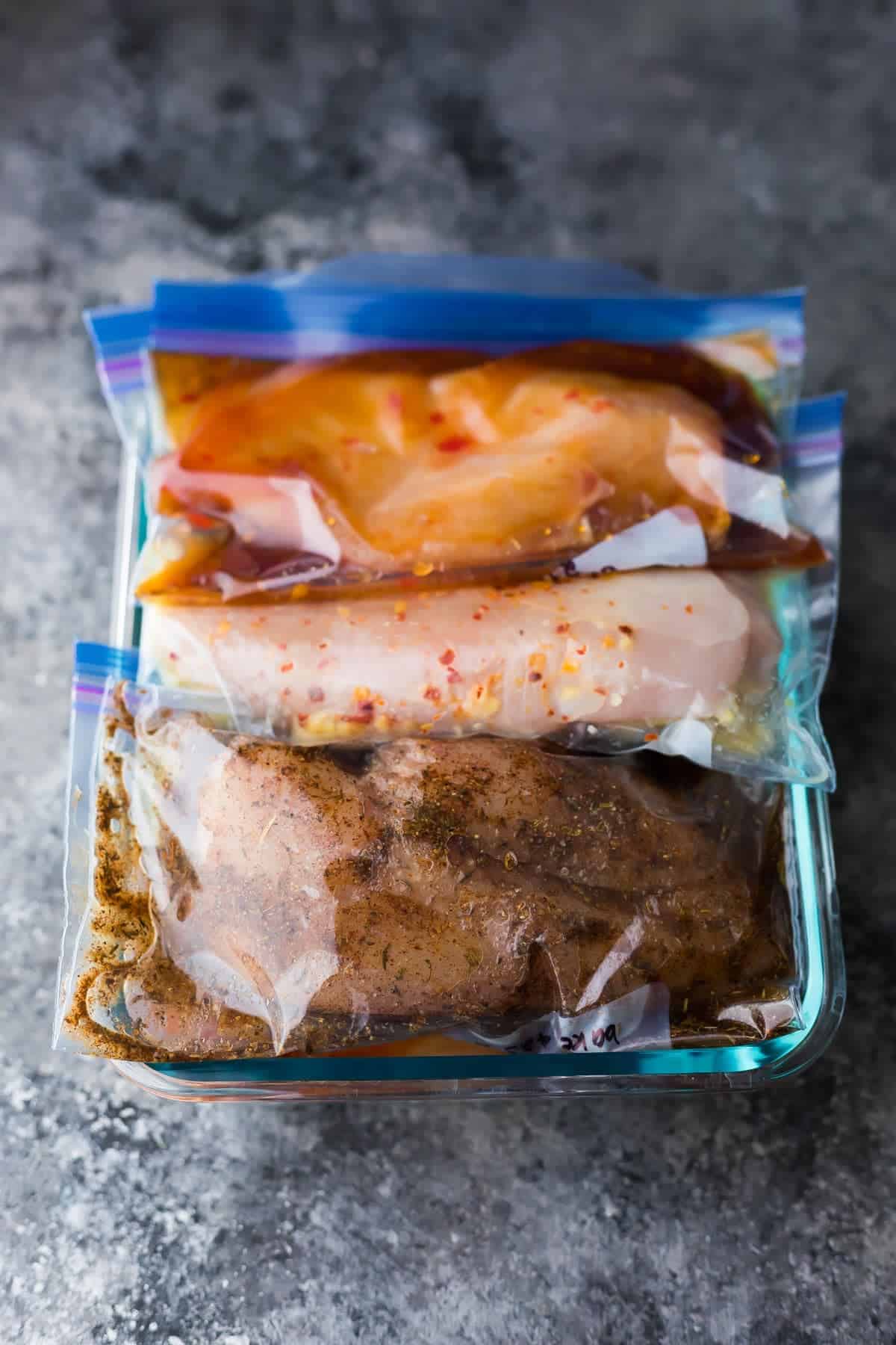 chicken marinade recipe in bags sitting in a glass container
