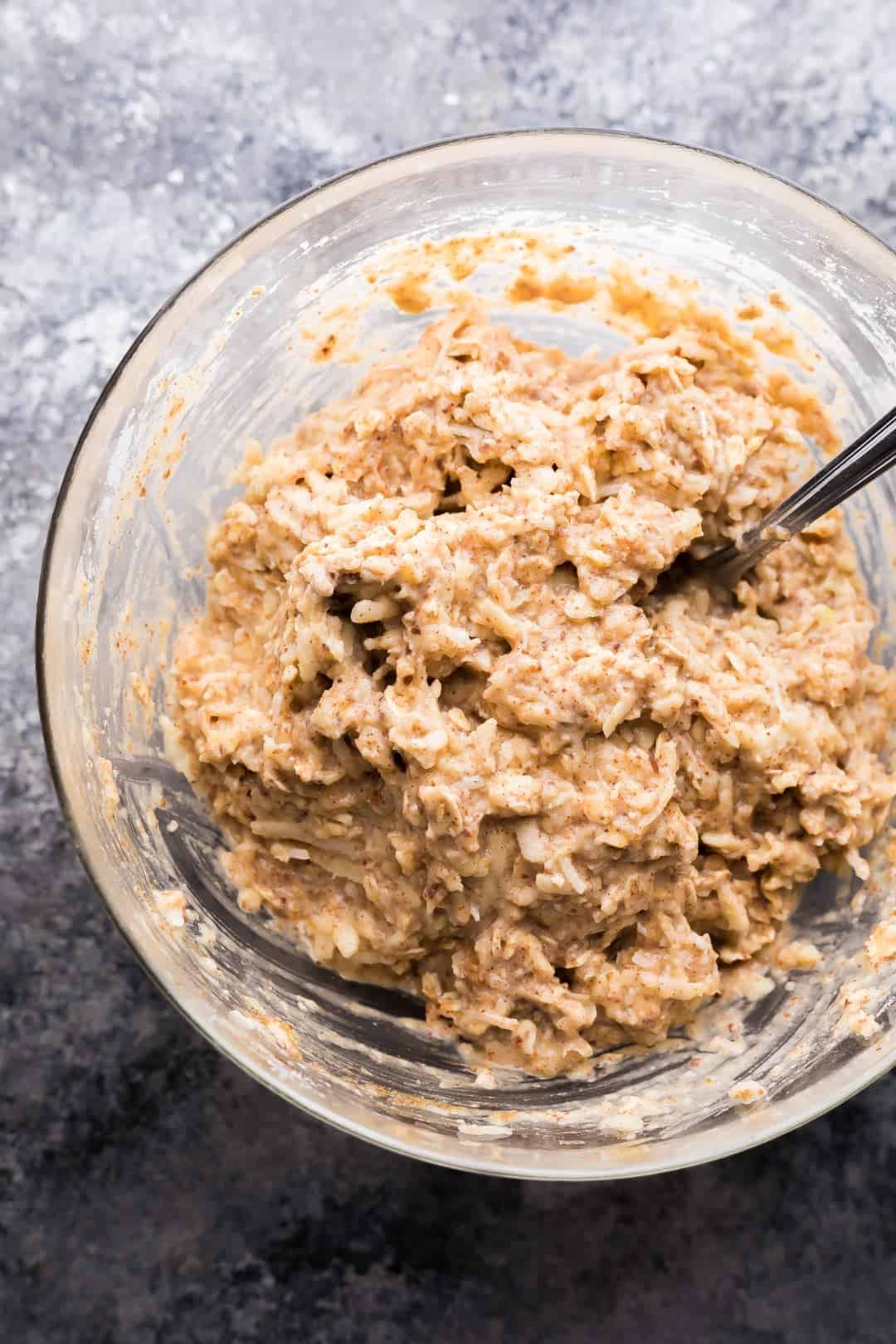 ingredients for Apple Almond Butter Snack Cookies after being stirred in glass mixing bowl