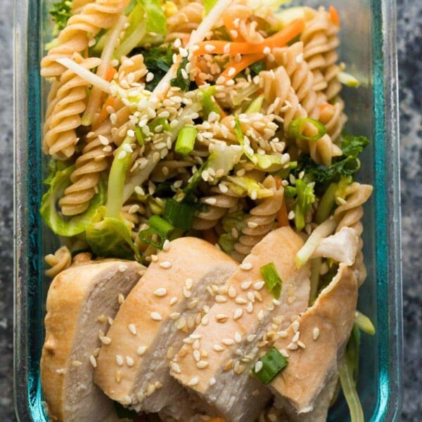 glass container with sesame chicken pasta salad lunch bowl