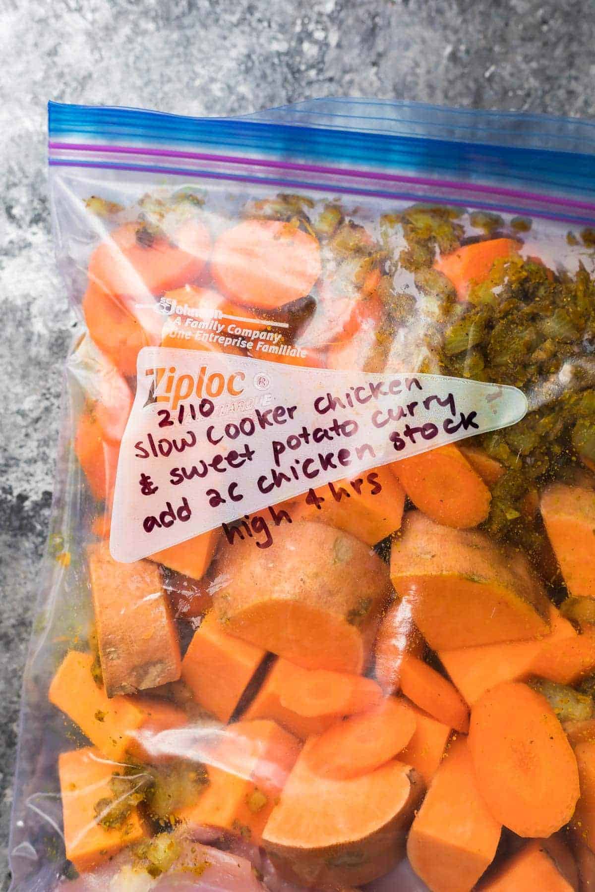 Freezer bag labeled with directions and ingredients for the Slow Cooker Sweet Potato Chicken Curry 
