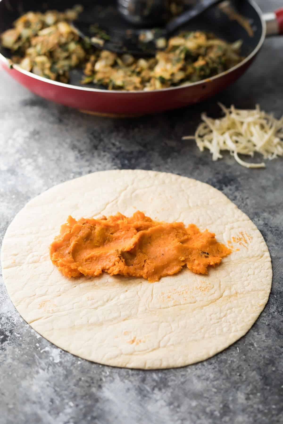 pureed sweet potato spread into a flour tortilla