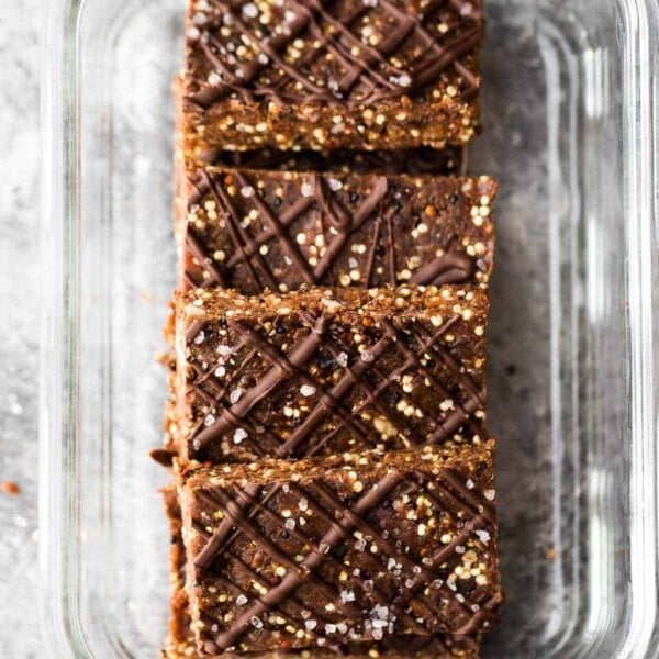 overhead shot of four chocolate almond quinoa snack bars in glass container