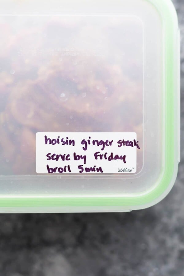 Close up view of tupperwear container with labbel saying hoisin ginger steak serve by Friday broil 5 min