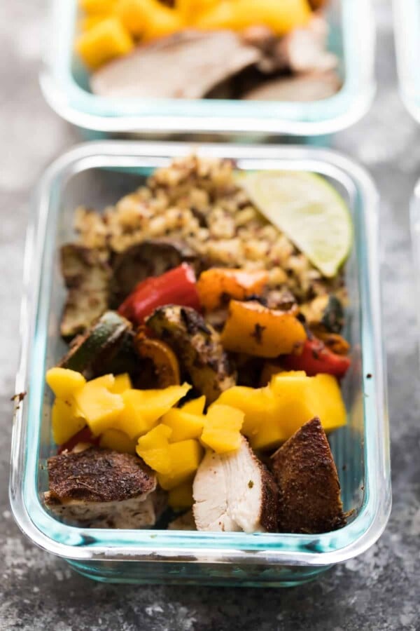 side shot of Jerk Chicken Meal Prep Lunch Bowls with lime wedge