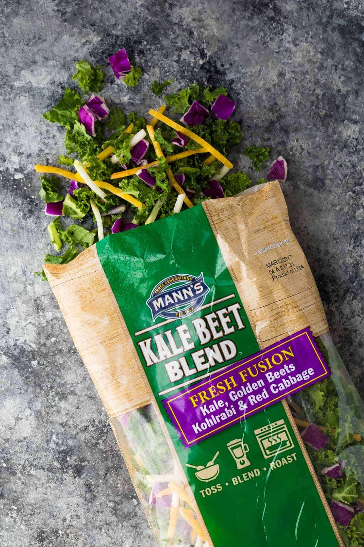 overhead view of a bag of Mann's Kale Beet Blend salad mix