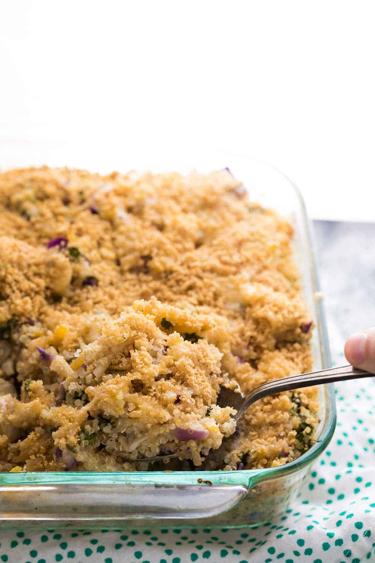 Chicken Quinoa Casserole with a spoon in the glass casserole dish after baking