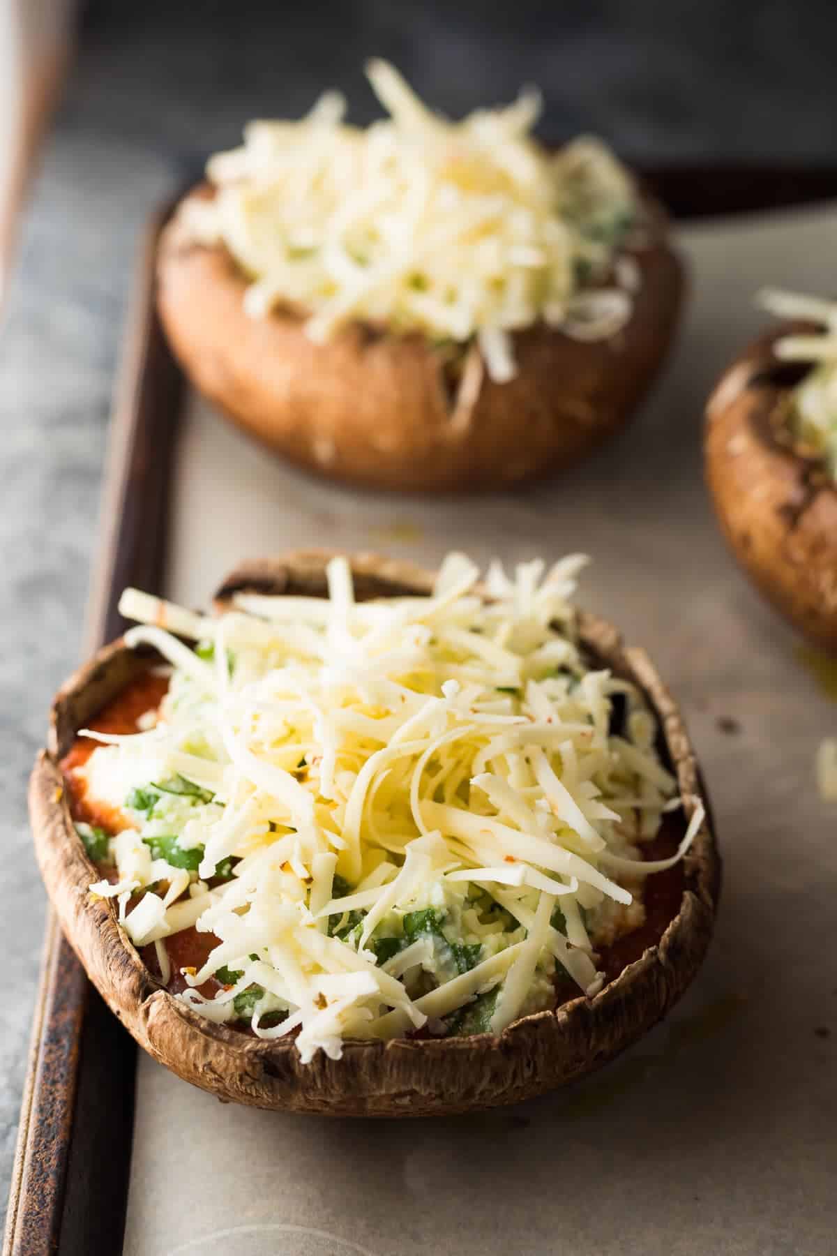 Close up view of Lasagna stuffed portobello mushroom on baking sheet before baking