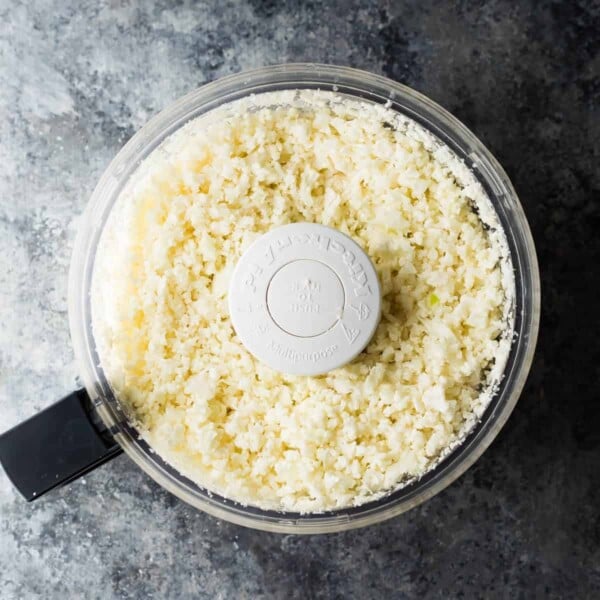 overhead view of food processor containing cauliflower rice